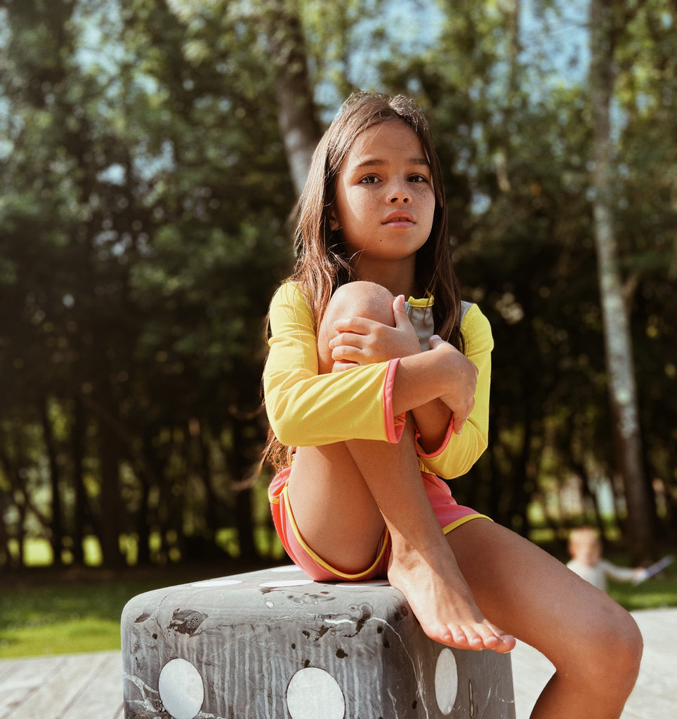 girl wearing the swimming suit sitting on a chair